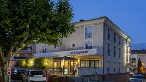 A building with a sign reading "RESTAURANT" at the entrance, a staircase leading up to the entrance, and parked cars in front. - The Originals Boutique, Hôtel l'Occitan, Aubagne Nord (La Destrousse)