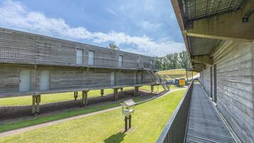 A long corridor with wooden walls and a covered walkway.