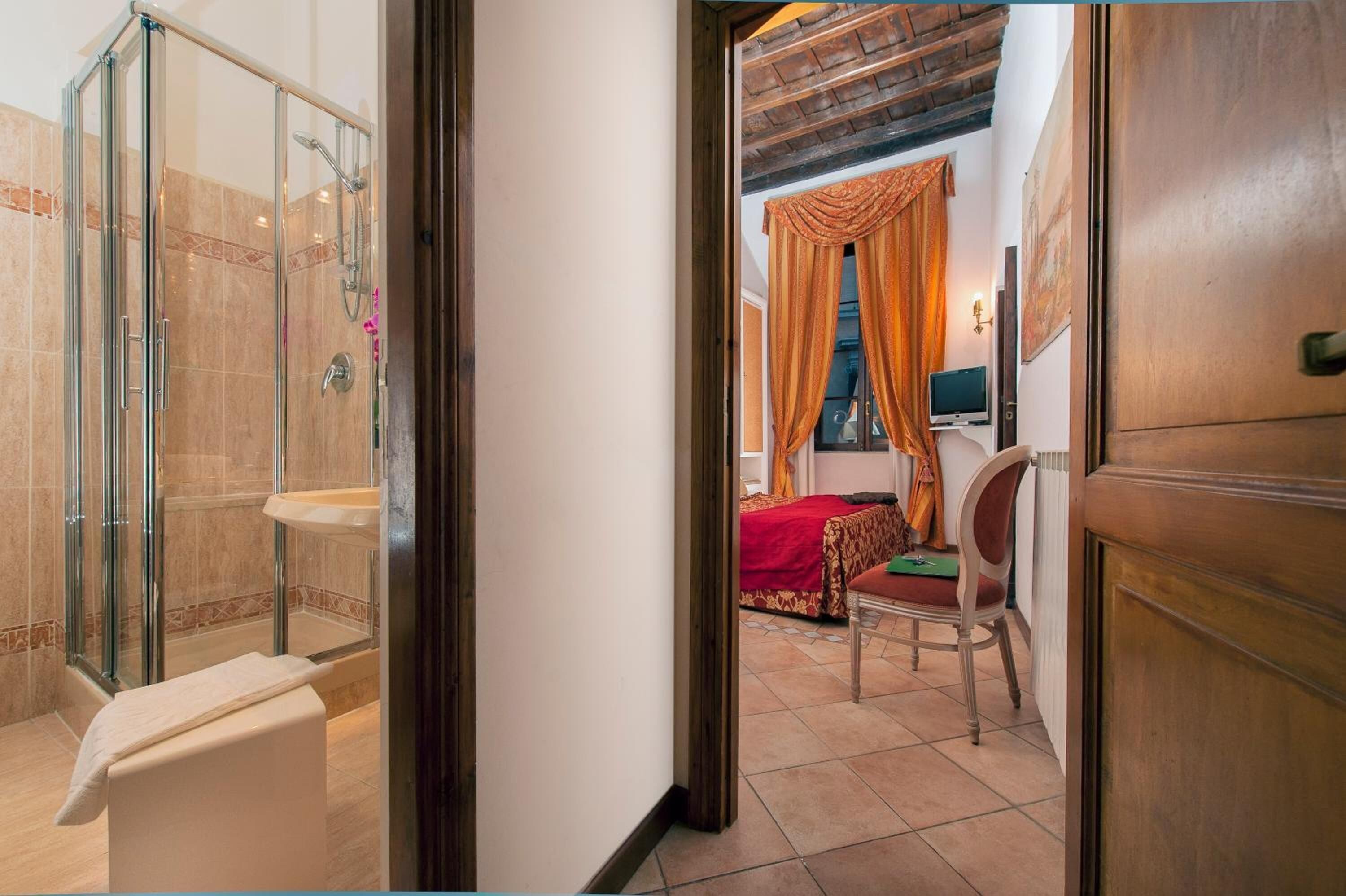 A bathroom with a glass shower enclosure, a sink, and a toilet.