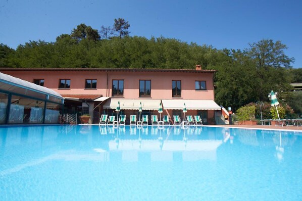 Seasonal outdoor pool, open 8:00 AM to 8:00 PM, pool umbrellas