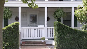 A two-story house with a white porch, a mailbox, and a number 400 sign. - Barclay Cottage (Virginia Beach)