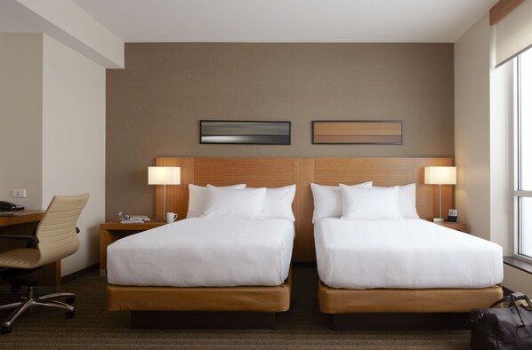A hotel room with two beds, a desk, a chair, and a window. - Hyatt Place Pune/Hinjawadi (Paud)