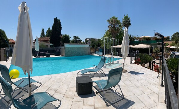 Seasonal outdoor pool, pool umbrellas, pool loungers
