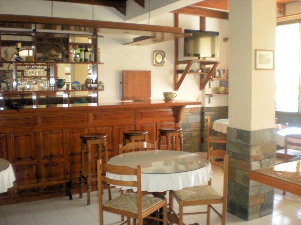 A bar area with wooden furniture and a stone accent wall.