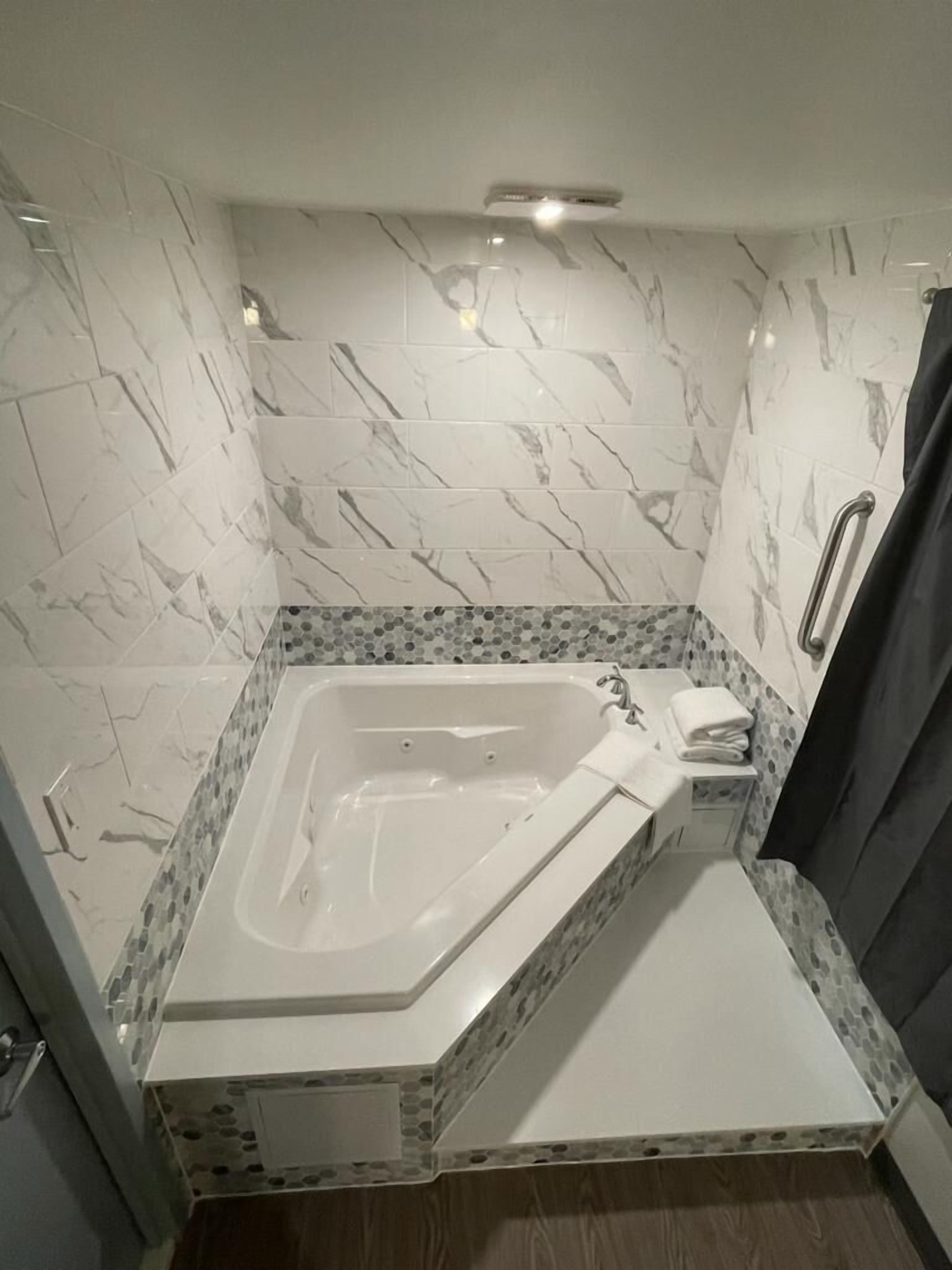 Romantic Room, 1 King Bed, Jetted Tub | Living area | 50-inch Smart TV with satellite channels, TV, video game console