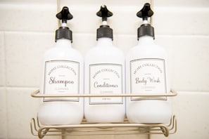 Three bottles of home collection cleaning products on a metal shelf. - Sunburst Inn (Indian Shores)