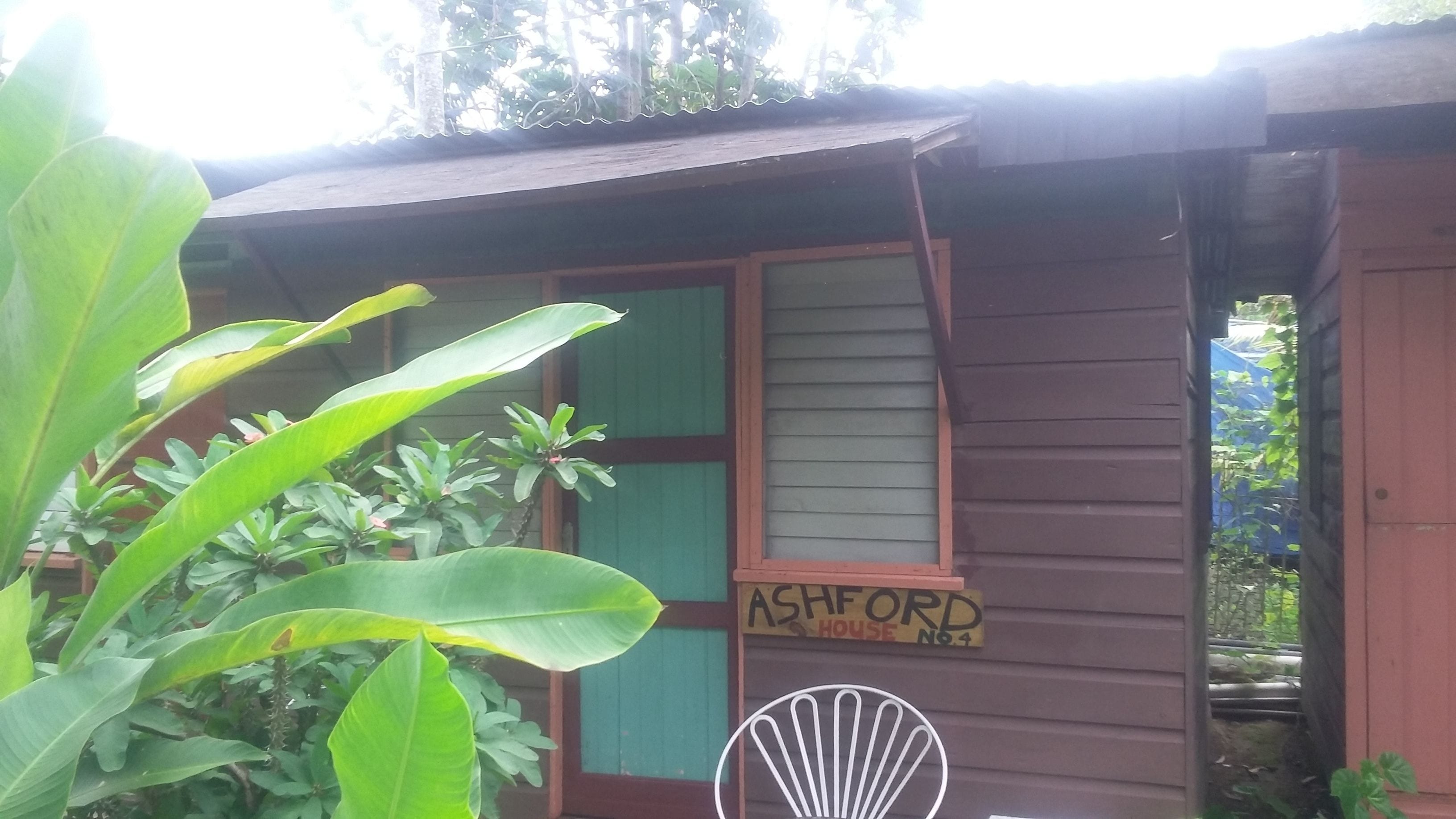 A wooden building with a sign reading "ASHFORD HOUSE No 4".