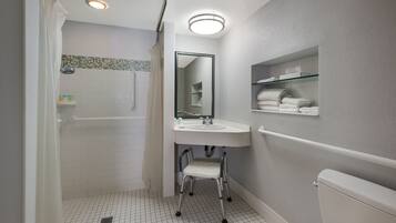 A modern bathroom with a shower, toilet, and sink.