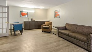 A compact living space with a kitchenette, a sofa, a chair, and a dining table. - Quality Inn Bristol Pinnacle Area (Bristol)
