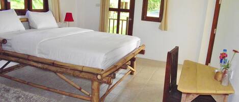 A room with a bed, a table, and a chair.