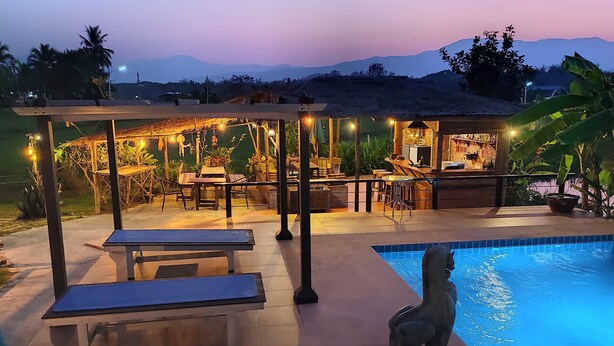 A poolside area with a covered seating area, a bar, and a view of mountains. - Country Retreat (Mae Rim)