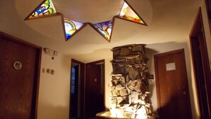 A hallway with a stone wall and stained glass windows. - Fairbanks Extended Stay (Fairbanks)