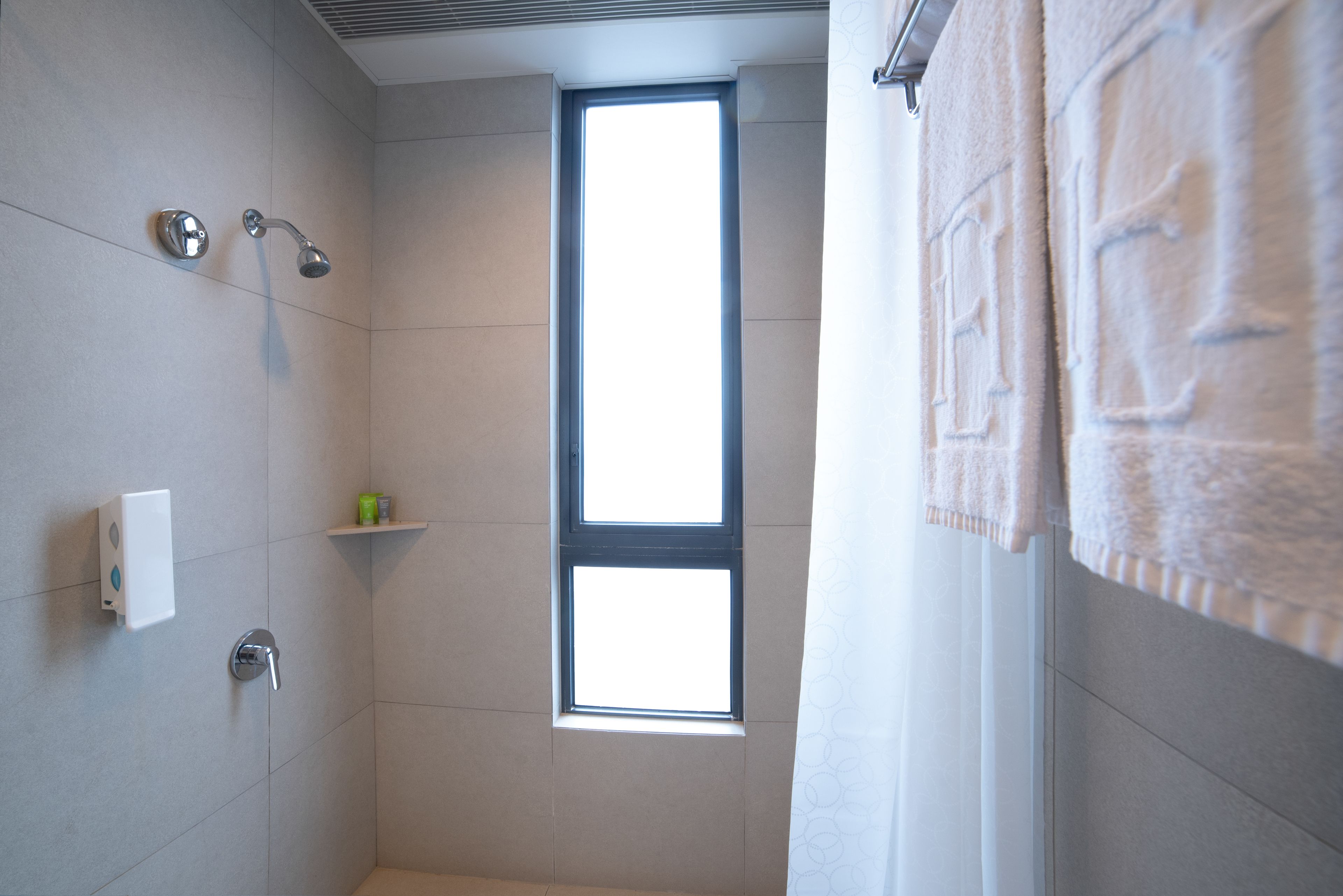 harbour view premier ease room | bathroom | rainfall showerhead, free toiletries, hair dryer, slippers