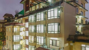 A multi-story hotel with balconies, large windows, and a rooftop terrace. - Fuji Hotel (Kathmandu)