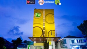 A hotel with a prominent vertical sign displaying the name 'Zest Hotel'. - Zest Bogor by Swiss-Belhotel International (Bogor)