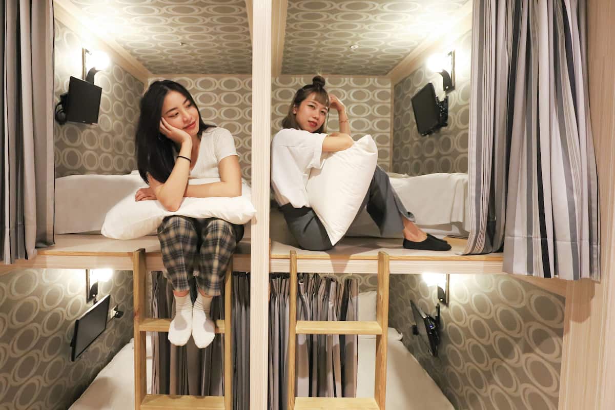 A room with a bunk bed, a mirror, and a television.