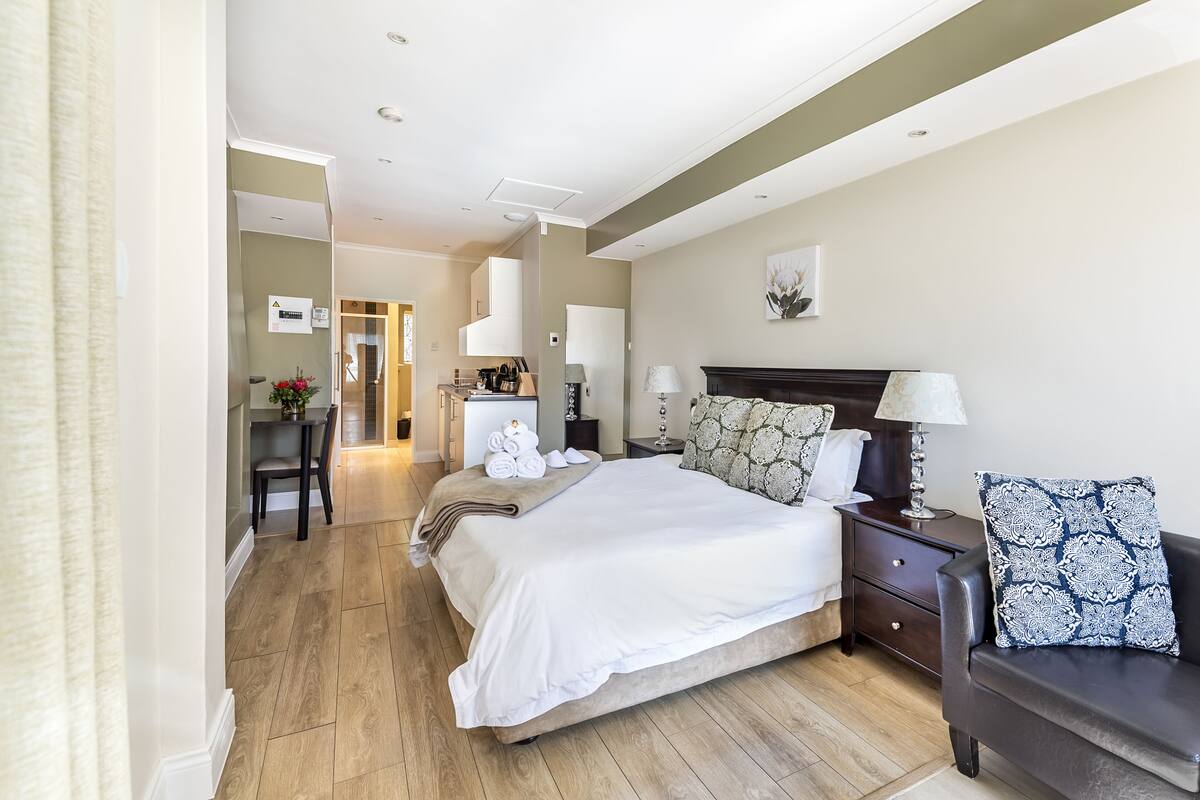Una habitación de hotel con una cama grande, un escritorio y una silla.