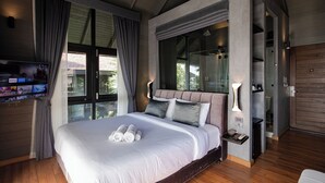 A modern bedroom with a large bed, a TV on the left, and a glass shower area. - The Tarna Resort, Koh Tao (Koh Tao)