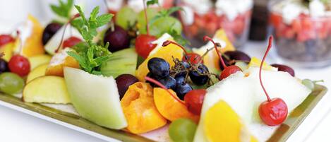 A variety of fruits and vegetables arranged on a tray.