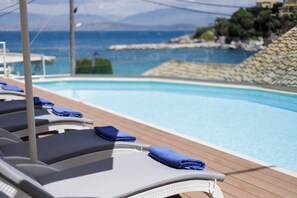 Seasonal outdoor pool, open 9:00 AM to 7:00 PM, pool umbrellas