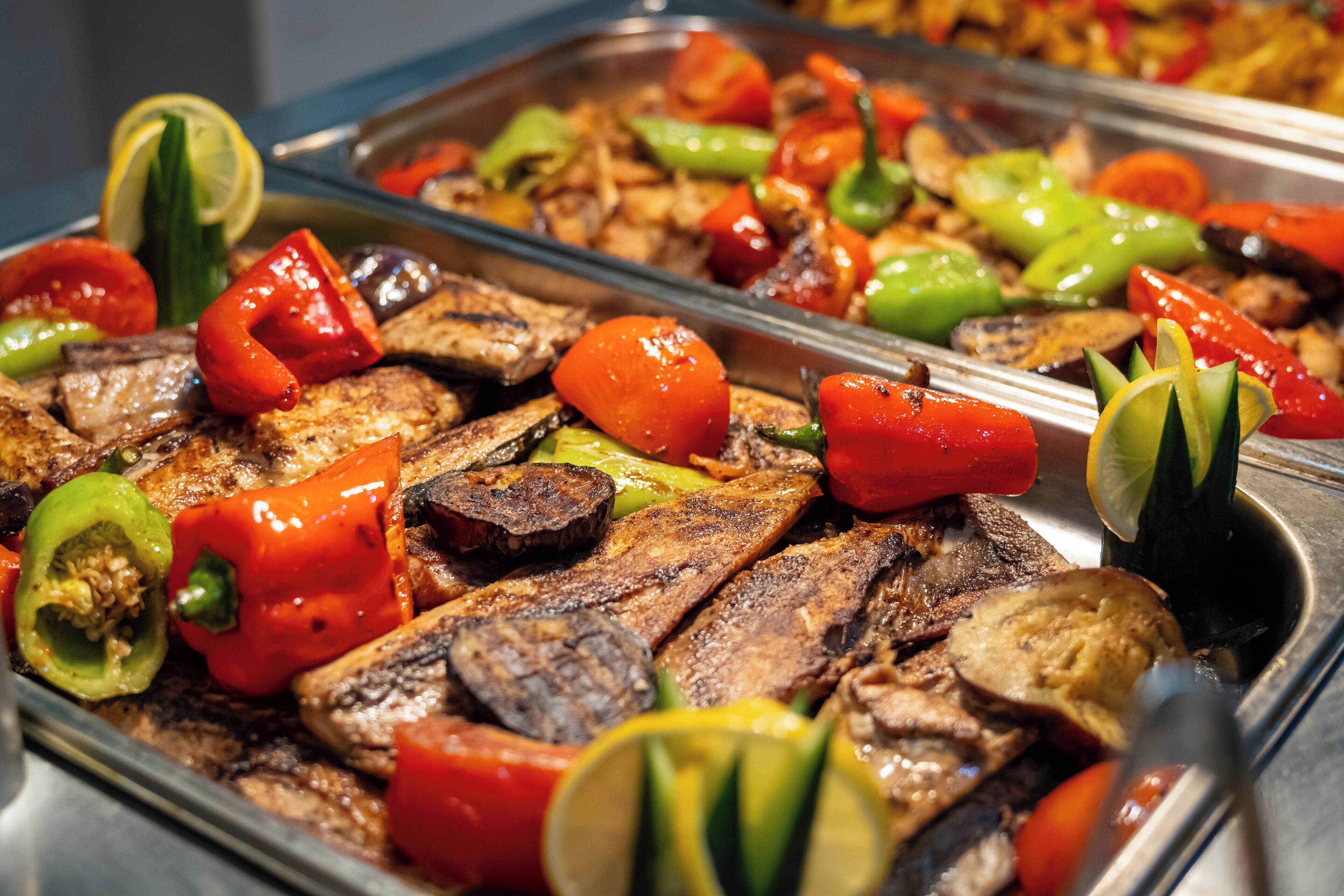 A buffet with grilled meats and vegetables.