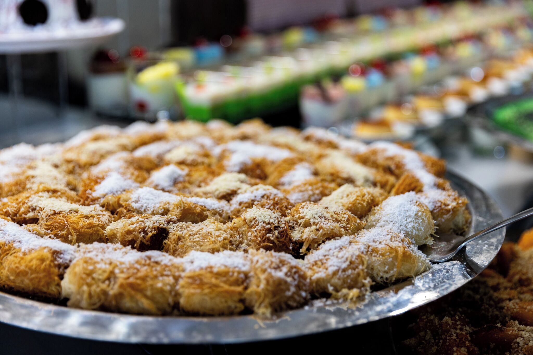 A tray of pastries dusted with powdered sugar.