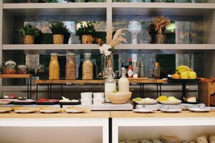 A buffet setup with various food items and condiments on display.