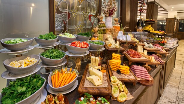 A buffet with various food items including salads, cheeses, meats, and appetizers. - MPM Sport Hotel (Bansko)