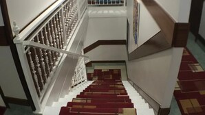 A staircase with a white railing and patterned carpet. - Pensión La Salve (Bilbao)