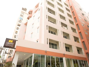 A multi-story building with a sign reading "Grand Living". - Grand Living Residence (Chiang Mai)