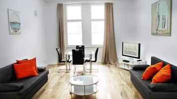 Deluxe Apartment, 1 Bedroom, Kitchen, Courtyard Area | Living area | Flat-screen TV