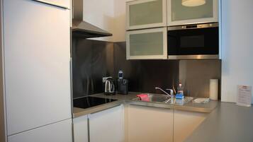 Deluxe Apartment, 1 Bedroom, Kitchen, Courtyard Area | Private kitchen | Full-sized fridge, microwave, stovetop, dishwasher