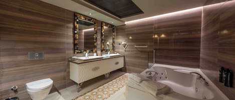 A modern bathroom with a vanity, a toilet, a bathtub, and a patterned floor.