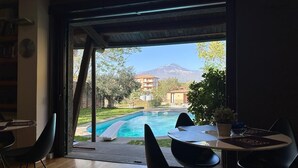 Una habitación con vista a una piscina y una montaña.