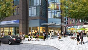 A modern building with a 'BISTRO' sign, surrounded by a pedestrian area with people walking and a parked car. - Global Luxury Suites Bethesda Chevy Chase (Bethesda)
