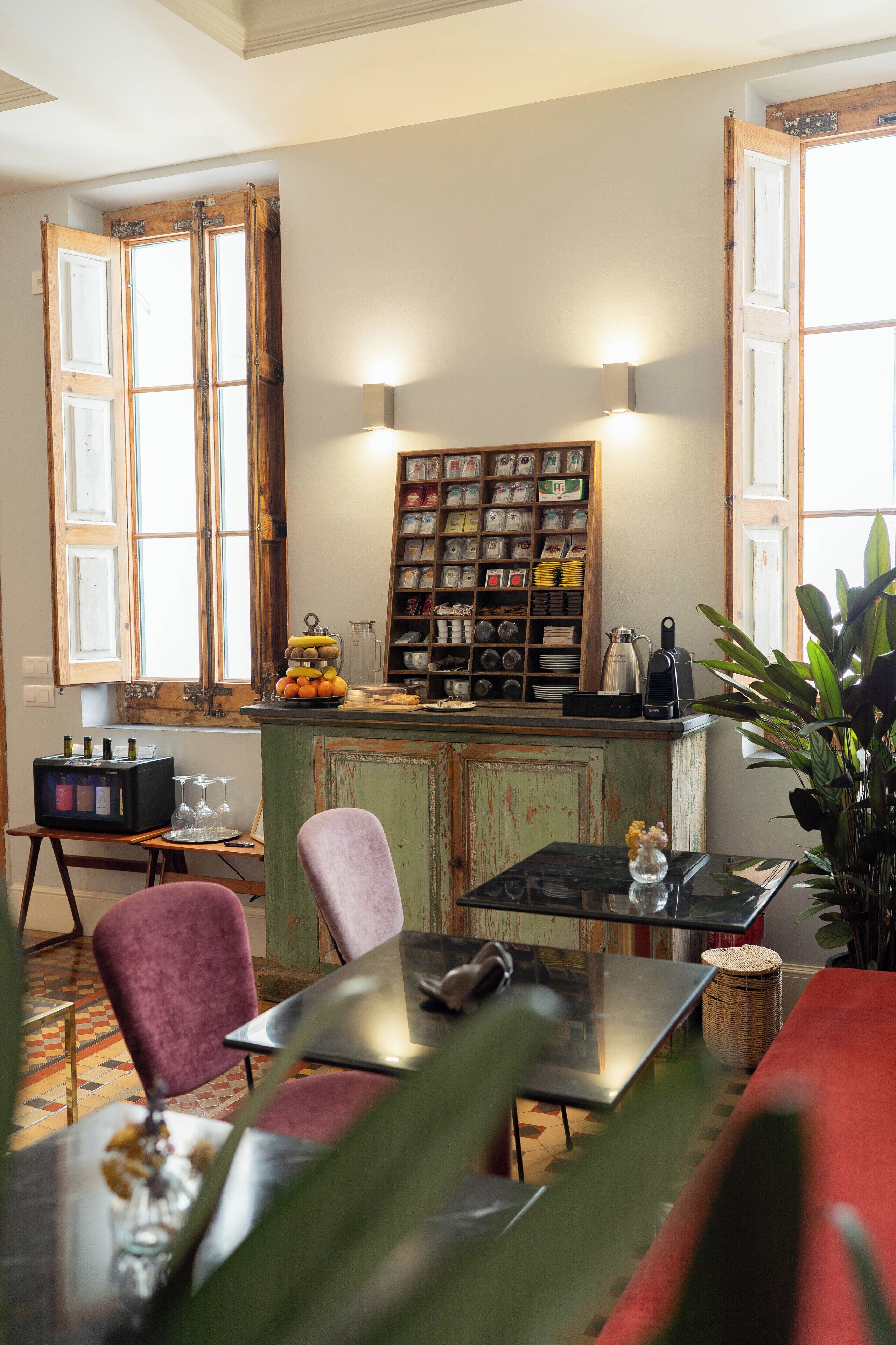 A cozy kitchen with wooden cabinets, a dining table, and a variety of kitchenware.