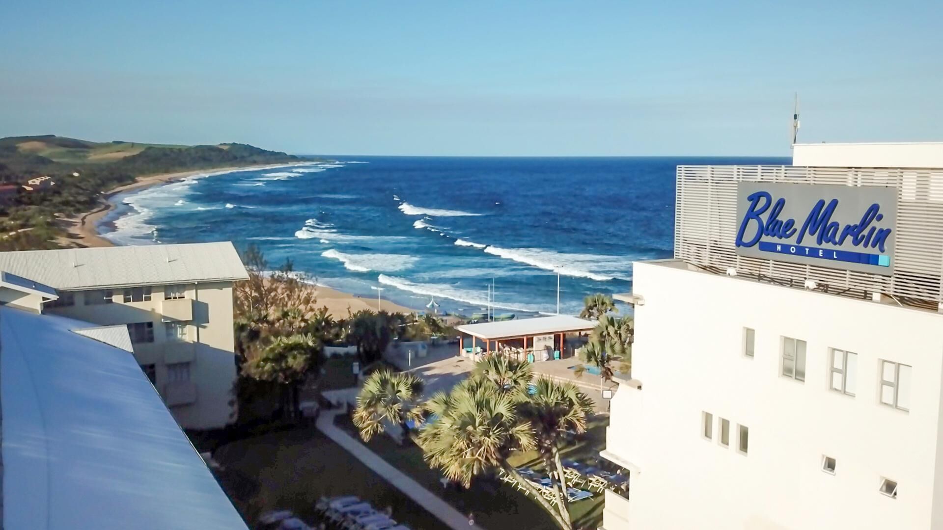 A coastal view with a building labeled 'Blue Marlin Hotel.'