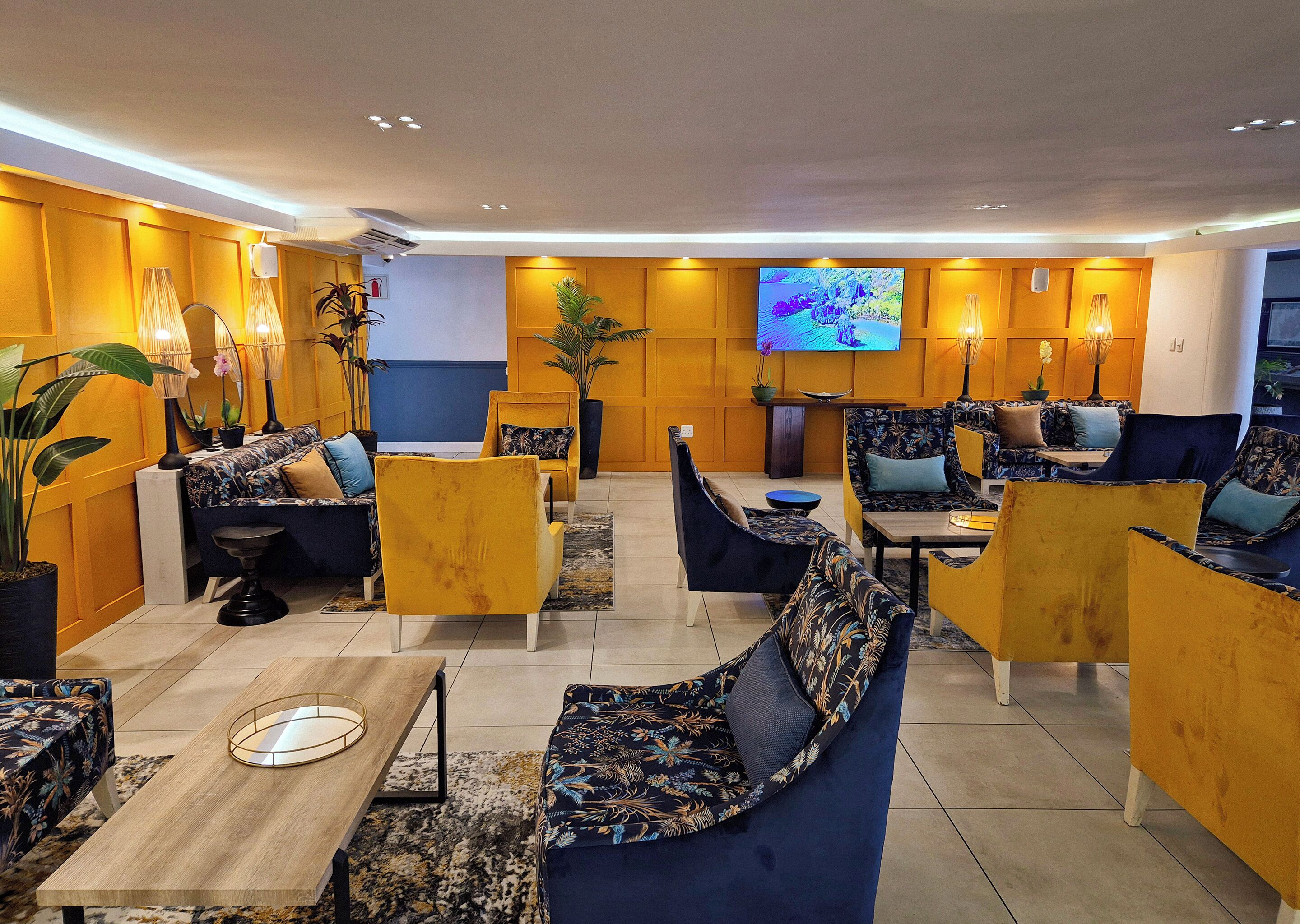 A modern lounge area with sofas, armchairs, and a coffee table.