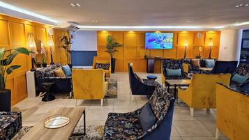 A modern lounge area with sofas, armchairs, and a coffee table.