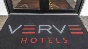 A black mat with the words "VERVE HOTELS" in white and red letters. - Peterborough by Verve (Peterborough)