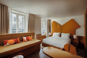 A hotel room with a bed, a sofa, a desk, and a window with curtains. - Palace Hotel (Paris)