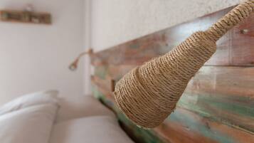 A beautifully crafted woven piece hangs from a wooden structure, showcasing intricate details.