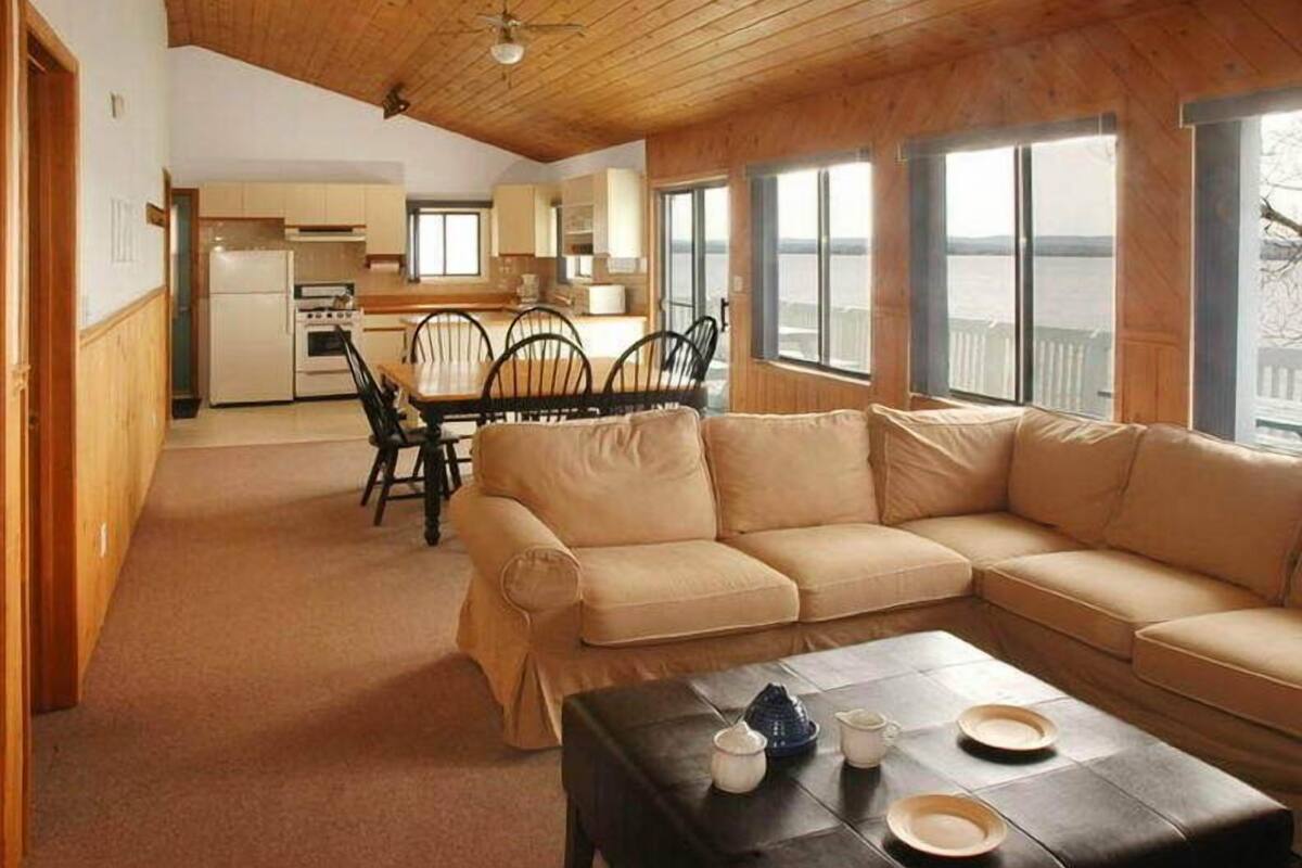 deluxe cottage, 3 bedrooms, fireplace, lake view | living area | flat-screen tv
