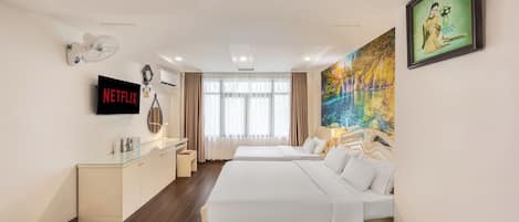 Family Triple Room | Minibar, in-room safe, iron/ironing board, free WiFi