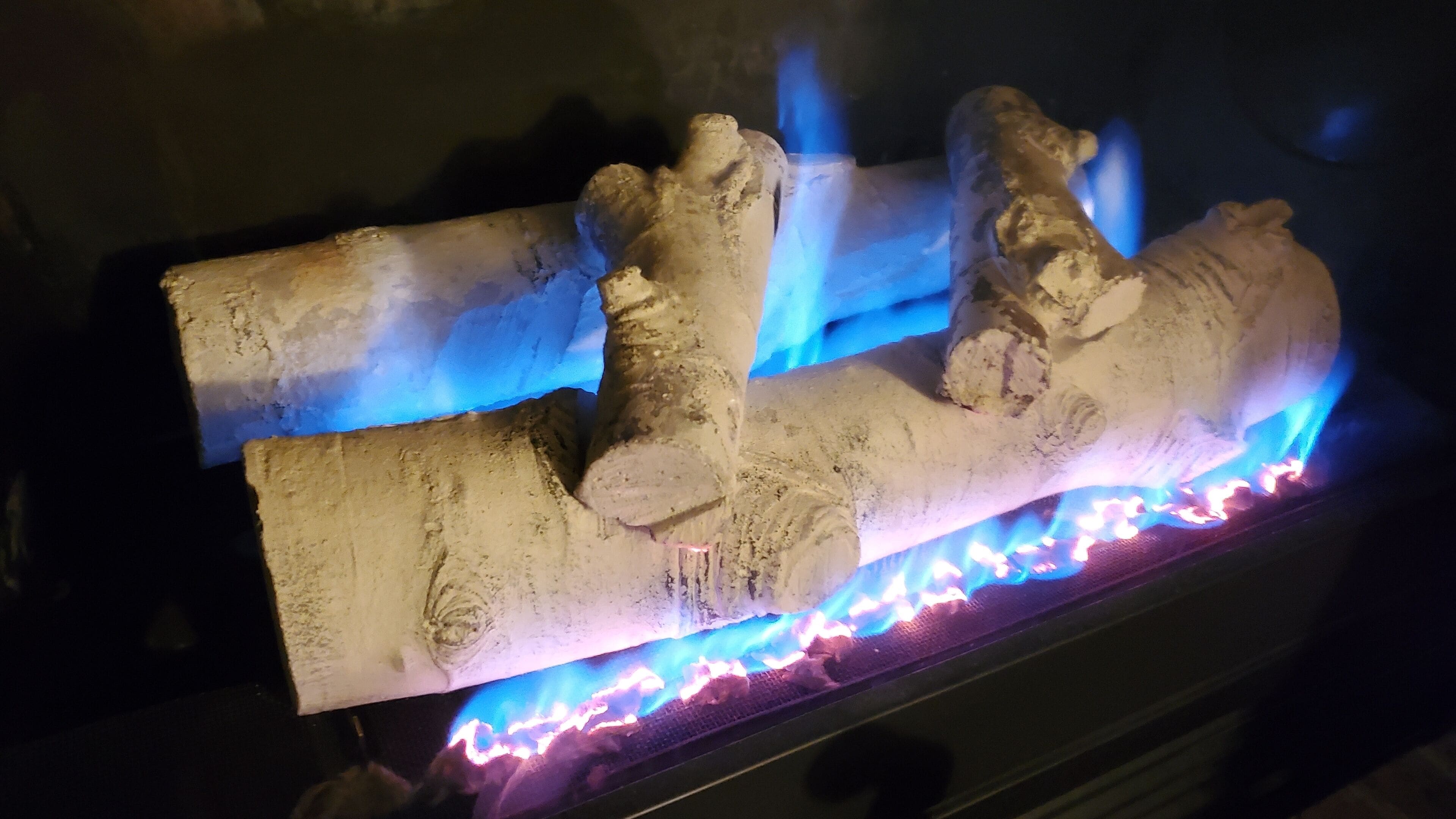 A fireplace with a log fire burning.