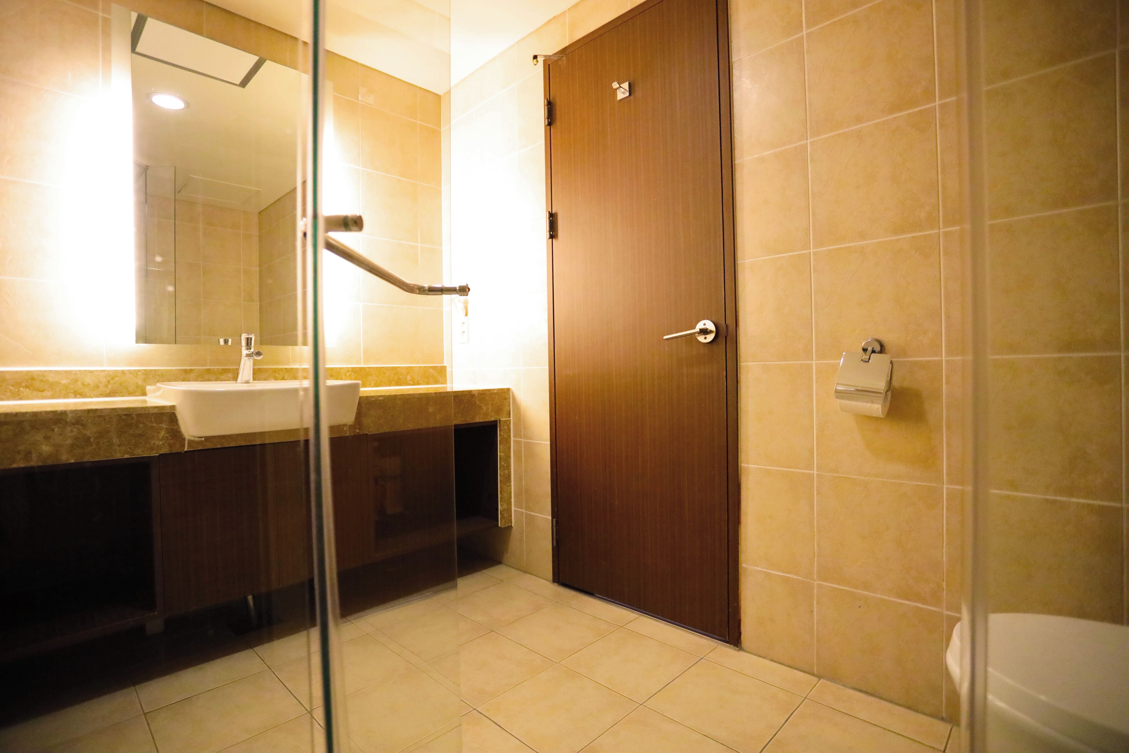 A bathroom with a sink, mirror, and toilet.