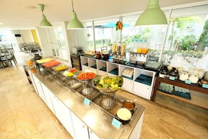 A buffet with various food items and a coffee station. - Sunday Beachfront View Jomtien Pattaya (Pattaya)