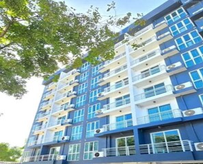A multi-story building with balconies and air conditioning units. - Sunday Beachfront View Jomtien Pattaya (Pattaya)
