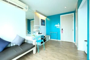 A modern room with a sofa, a dining table, a chair, and a white door.