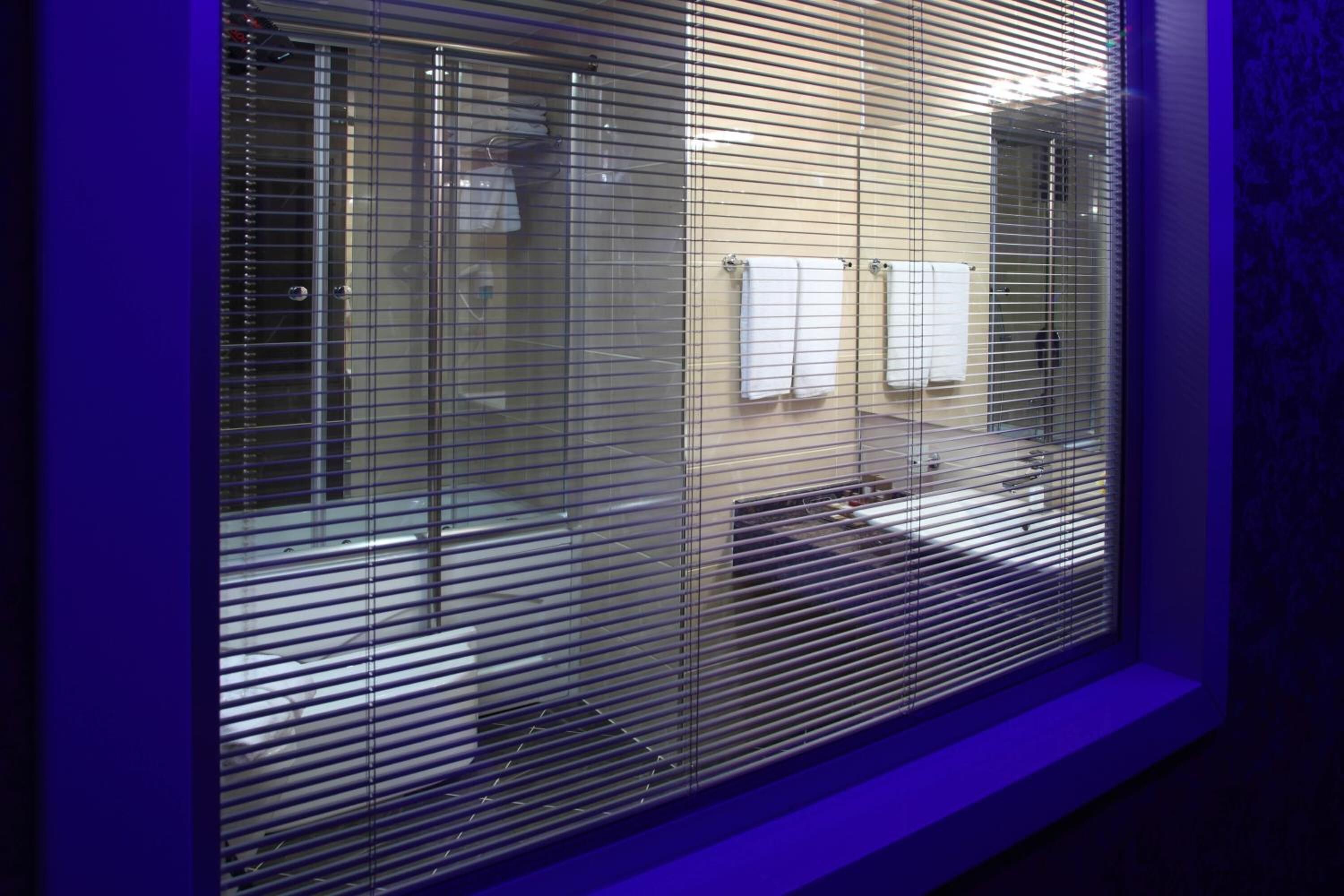 A bathroom with a shower, a toilet, and a sink.